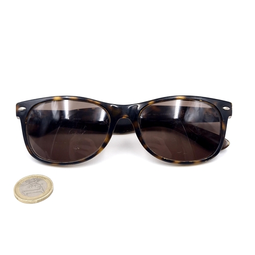 A pair of Ray-Ban wayfarer faux tortoise shell frame sunglasses. Slight blemish to lenses.