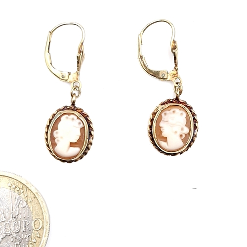 A pair of nine carat gold cameo antique earrings suitable for pierced ears. Boxed.