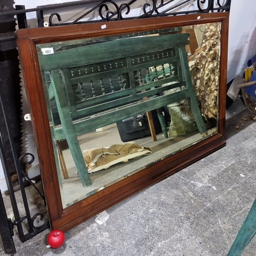 683 - Vintage rectangular wall mirror with a wooden frame from the 20th century. It has a polished surface... 