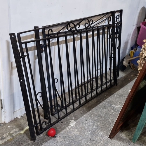 684 - Star Lot : Wrought iron gate from the 20th century features ornate scrollwork and a black finish, me... 