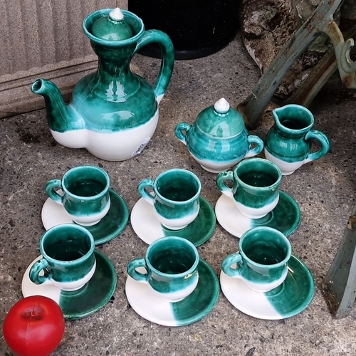 1255 - Ceramic green and white art studio pottery tea set, featuring a teapot, creamer, sugar bowl, and six... 