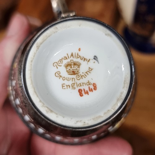 140 - Two Royal Albert Crown China cup and saucer sets paired with sterling silver cup holders, hallmarked... 