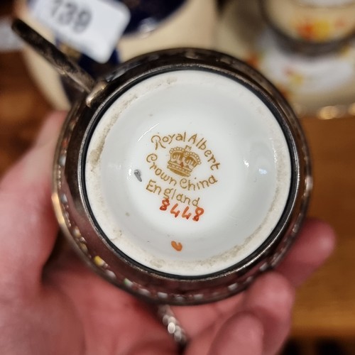 140 - Two Royal Albert Crown China cup and saucer sets paired with sterling silver cup holders, hallmarked... 