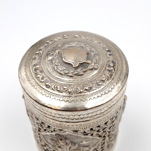 8 - A most attractive profusely decorated Indian silver canister with lid. Dimensions: 7 cms diameter. H... 