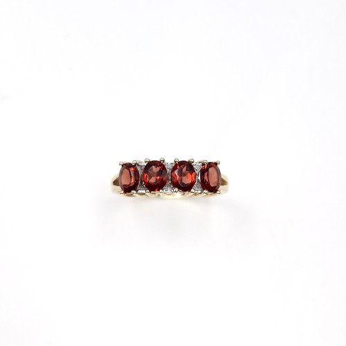 31 - Star Lot : A nine carat gold garnet ring set with diamonds. Ring size - P. Weight - 2.36 grams.