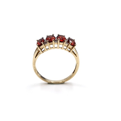 31 - Star Lot : A nine carat gold garnet ring set with diamonds. Ring size - P. Weight - 2.36 grams.