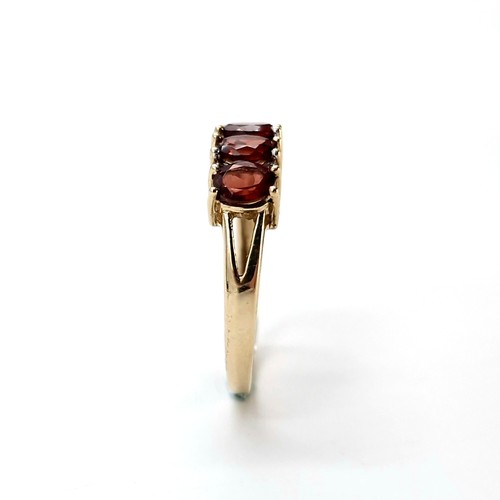 31 - Star Lot : A nine carat gold garnet ring set with diamonds. Ring size - P. Weight - 2.36 grams.