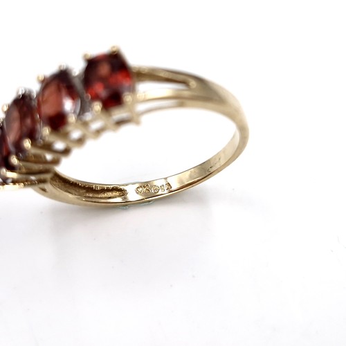 31 - Star Lot : A nine carat gold garnet ring set with diamonds. Ring size - P. Weight - 2.36 grams.