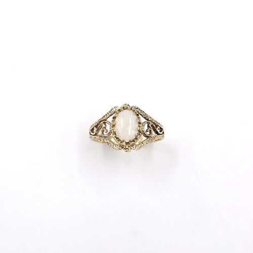 32 - Star Lot : A very pretty nine carat gold opal ring with scroll mount. Ring size - N. Weight - 1.99 g... 