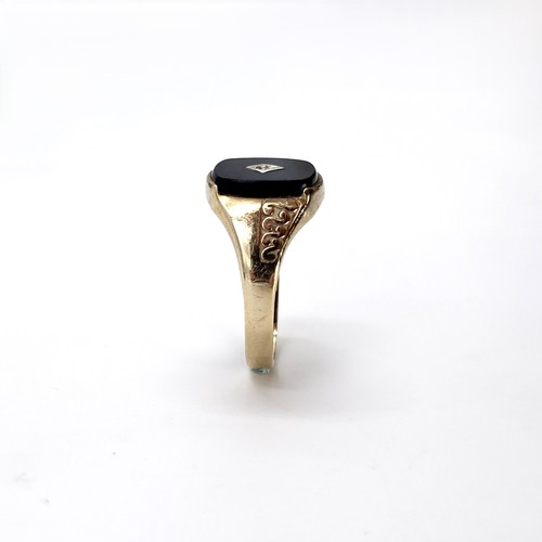 33 - Star lot : A nine carat gold gents onyx and diamond signet ring. Size - S. Weight - 2.54 grams.