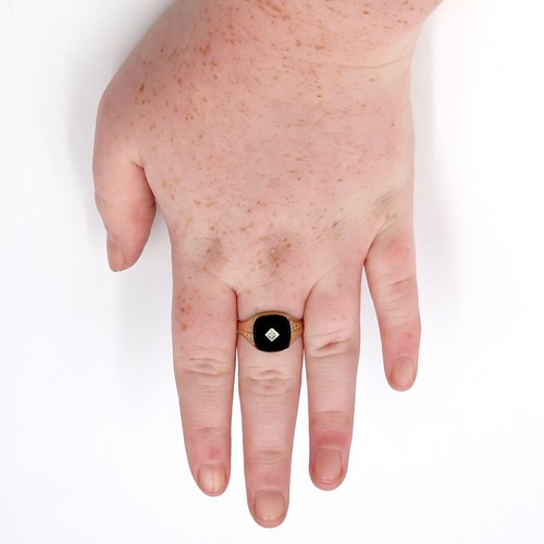 33 - Star lot : A nine carat gold gents onyx and diamond signet ring. Size - S. Weight - 2.54 grams.