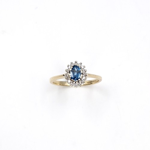 35 - Star lot : A nine carat gold blue topaz and diamond set ring. Size - P. Weight - 2.28 grams.