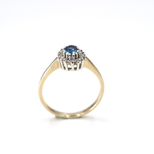 35 - Star lot : A nine carat gold blue topaz and diamond set ring. Size - P. Weight - 2.28 grams.