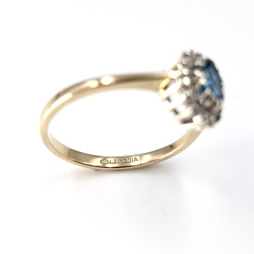 35 - Star lot : A nine carat gold blue topaz and diamond set ring. Size - P. Weight - 2.28 grams.