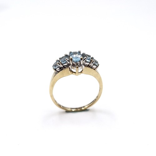 36 - Star Lot : A nine carat gold blue topaz cluster set ring. Size - M 1/2. Weight - 2.6 grams.