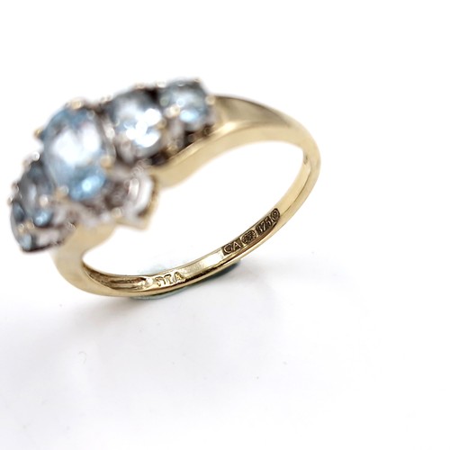 36 - Star Lot : A nine carat gold blue topaz cluster set ring. Size - M 1/2. Weight - 2.6 grams.