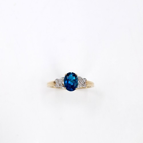 38 - Star Lot :  A beautiful nine carat gold faceted cut blue  topaz and diamond ring. Size - R. Weight -... 