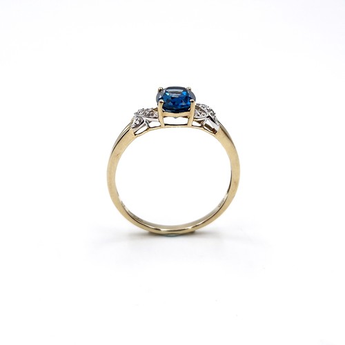 38 - Star Lot :  A beautiful nine carat gold faceted cut blue  topaz and diamond ring. Size - R. Weight -... 