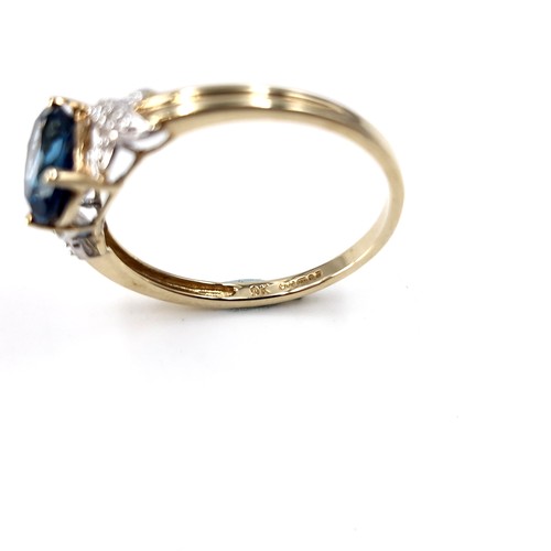 38 - Star Lot :  A beautiful nine carat gold faceted cut blue  topaz and diamond ring. Size - R. Weight -... 