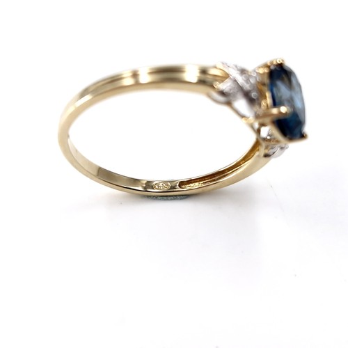 38 - Star Lot :  A beautiful nine carat gold faceted cut blue  topaz and diamond ring. Size - R. Weight -... 