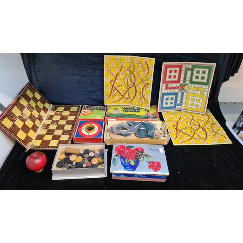 121 - Seven charming vintage board games including Target Tidley Winks and Snakes & Ladders.