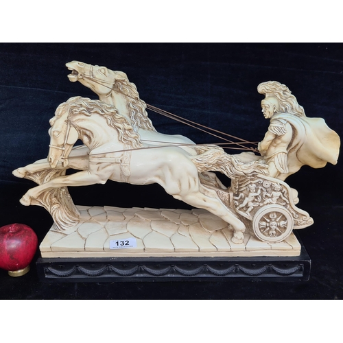 132 - A large and heavy resin statue featuring a Roman chariot and charging horses. Stamped LT Pat to base... 