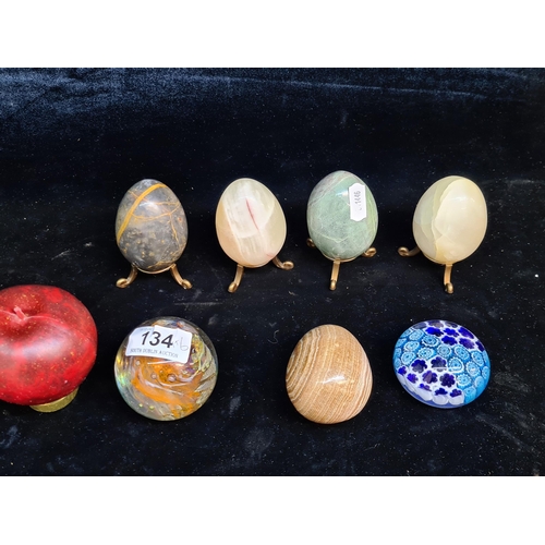 134 - Two art glass paper weights including a pretty Millefiori example. Also includes five marble eggs.