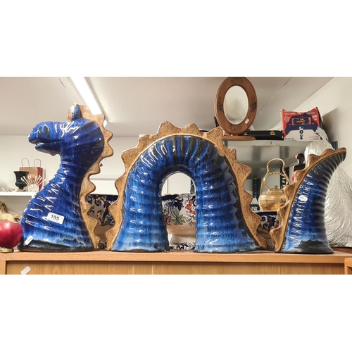 195 - A large brilliant blue glazed, ceramic Loch Ness Monster. Comes in three pieces which can be display... 