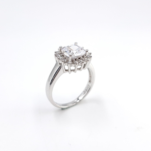 23 - An attractive large white cluster ring set in sterling silver. Size - R. Weight - 5.19 grams.