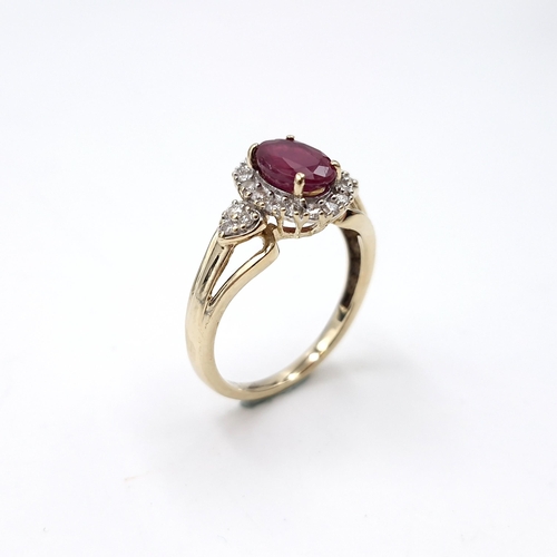 9 - Star lot : A nice example of a ruby stone ring with diamond surround set in nine carat gold. Size - ... 