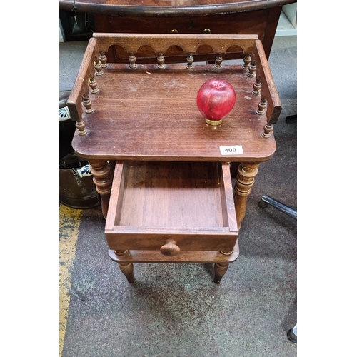 409 - Wooden side table with turned legs, a single drawer, and a spindled gallery rail.