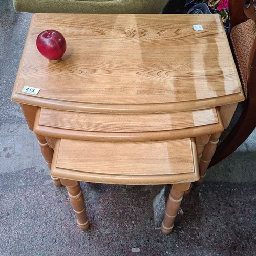 413 - Nest of three vintage maple tables feature charming turned legs and natural wood grain.