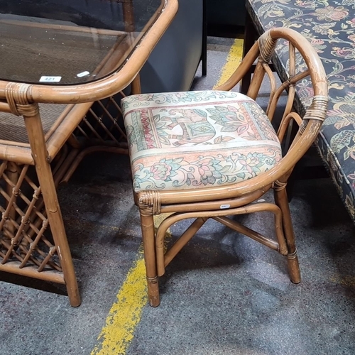 421 - Vintage bamboo three piece bistro set, featuring a glass-top table and rattan chair with floral tape... 