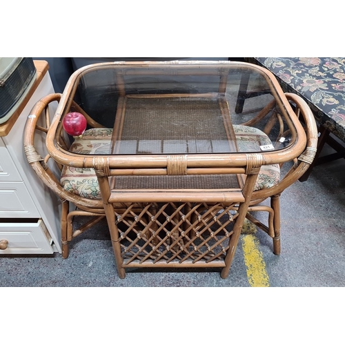 421 - Vintage bamboo three piece bistro set, featuring a glass-top table and rattan chair with floral tape... 