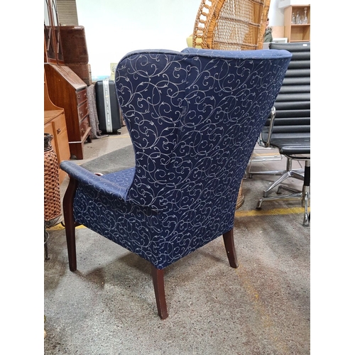 428 - Star Lot : A very handsome Vintage Wingback Armchair: Elegant wood frame with swirling patterned uph... 