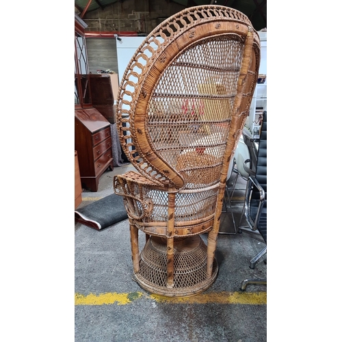 429 - Star Lot : A fabulous 1970s wicker peacock chair with intricate lattice design and a blue cushion.