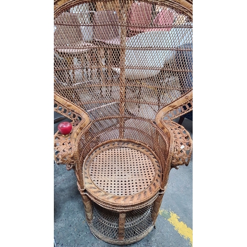 429 - Star Lot : A fabulous 1970s wicker peacock chair with intricate lattice design and a blue cushion.