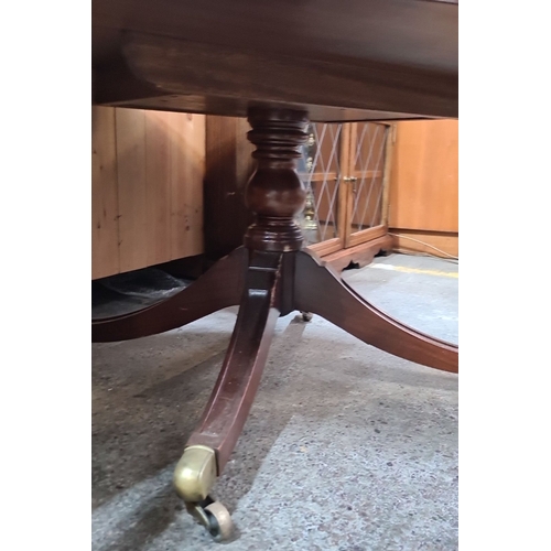 447 - Vintage round glass-top coffee table with brass casters and decorative inlaid tooled leather interio... 