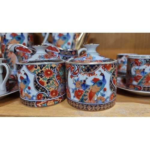 458 - Japanese Kutani porcelain tea set, vibrant floral motifs, from the mid-20th century. Includes teapot... 