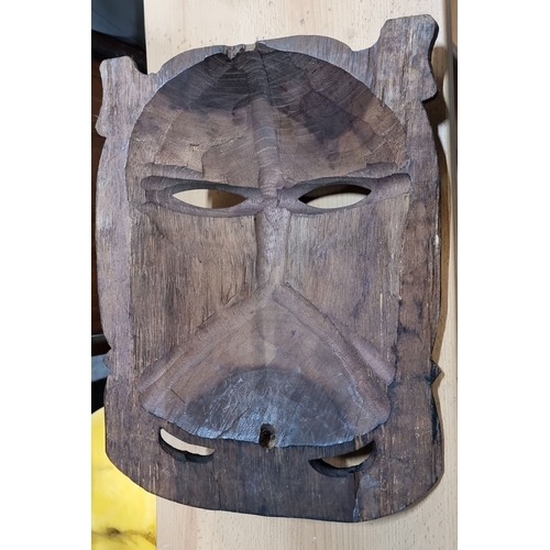 474 - Hand-carved African wooden mask, featuring dual faces and intricate detailing.