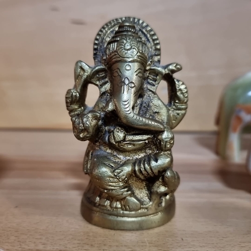 488 - Eclectic elephant figurine lot, featuring various materials and styles. Includes brass Ganesh statue... 