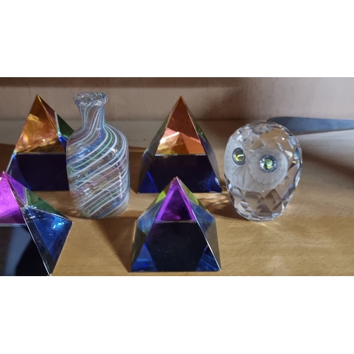 493 - Glass pyramid collection, including faceted crystal owl and swirl-patterned mini vase.