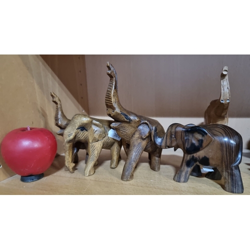 495 - Collection of hand-carved wooden elephants, polished finish.