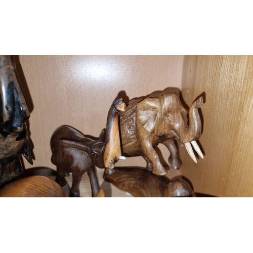 498 - Collection of carved wooden elephant figures with various finishes.