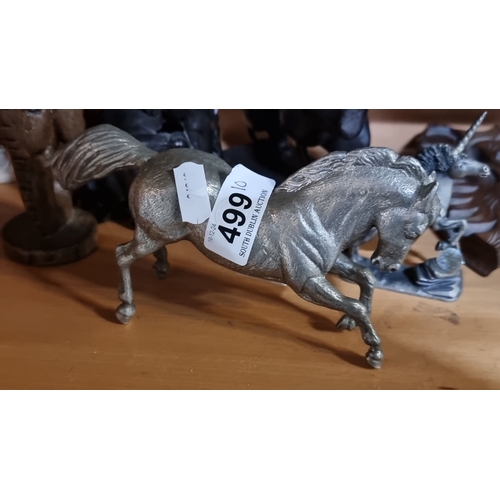 499 - Eclectic figurine collection includes metallic horse, mythical creatures, and wooden sculptures.