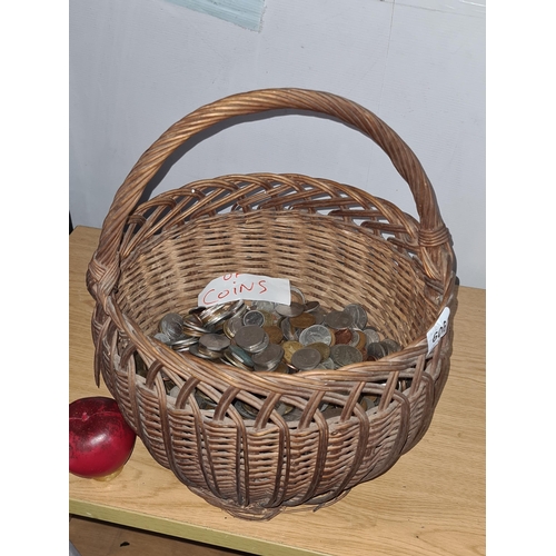 606 - A woven basket containing 9 kilograms worth of Irish coinage. unchecked