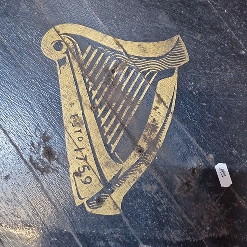 816 - Star let : An oak black barrel table with Guinness branding and harp emblem. From the mid-20th centu... 