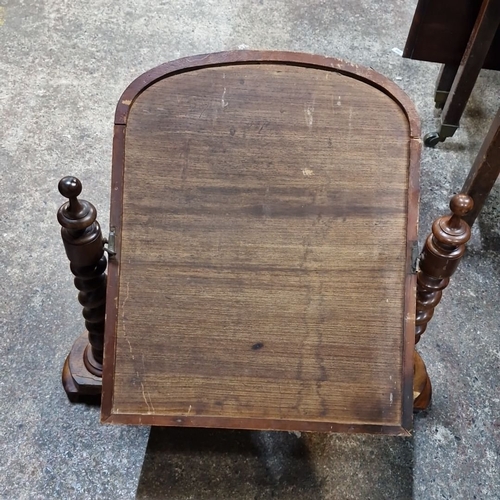 821 - Star Lot : A handsome Victorian swivel vanity mirror features turned wooden spindles and rich patina... 