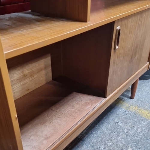 828 - Star Lot : A Mid-century modern wall unit, featuring adjustable shelving and drop-down drinks cabine... 