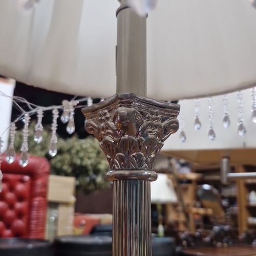 830 - Pair of silver-plated table lamps with crystal fringe and classical column design.  From the fabulou... 